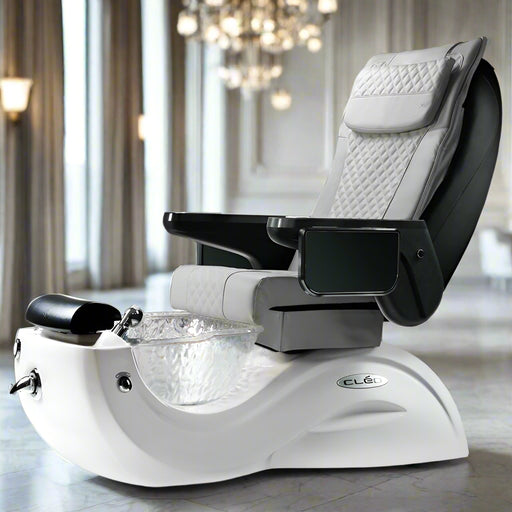 A modern pedicure spa chair with a glass bowl, black and gray seating area, and white base. It includes armrests with cup holders and USB charging ports, and features a pedicure stool and pipe-less whirlpool system.