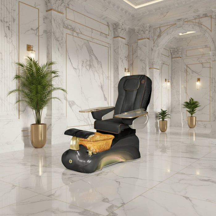Black and gold pedicure chair with foot basin in a room setting.