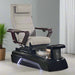 A black pedicure spa chair with a wooden armrest and base, featuring airbag movement technology and a built-in basin with LED lighting.