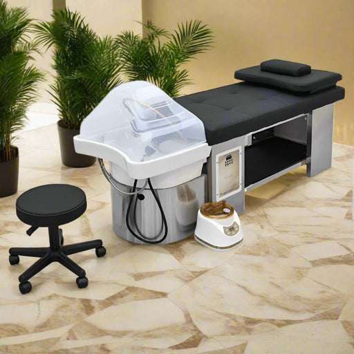 Salon treatment table with hair washing station and stool in a spa setting
