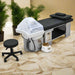 Salon treatment table with hair washing station and stool in a spa setting