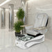 A modern La Fleur 4 Pedicure Spa chair with an adjustable footrest, contoured backrest, and a retractable spray head and hose, in a sleek white color with orange accents.