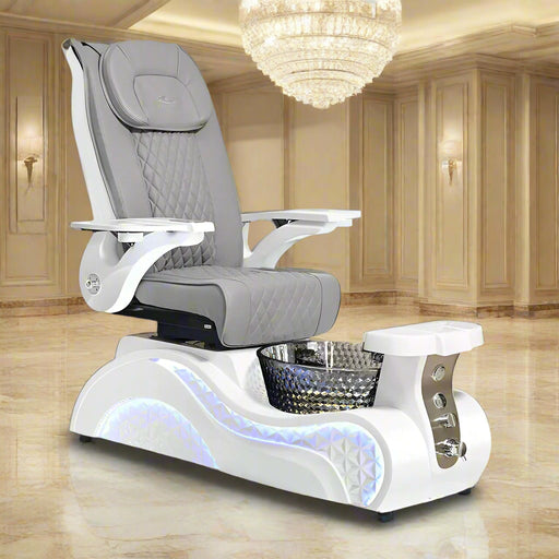 A luxurious pedicure spa chair with diamond-textured gray faux leather, an iridescent 'Mother of Pearl' finished crystal basin, and built-in massage programs. It also shows foldable gloss wood trays and armrests with integrated purse hooks.