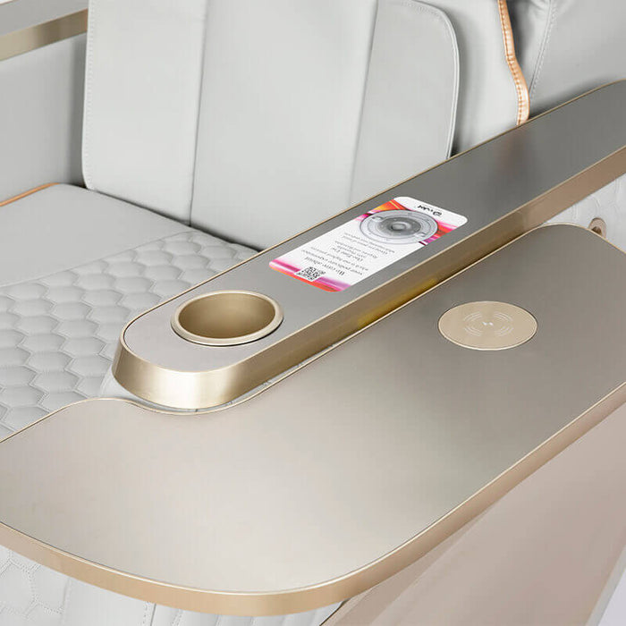Modern airplane seat tray table with cup holder and phone charger.