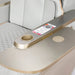 Modern airplane seat tray table with cup holder and phone charger.