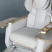 Luxury airplane seat with quilted design and gold accents on a dark background