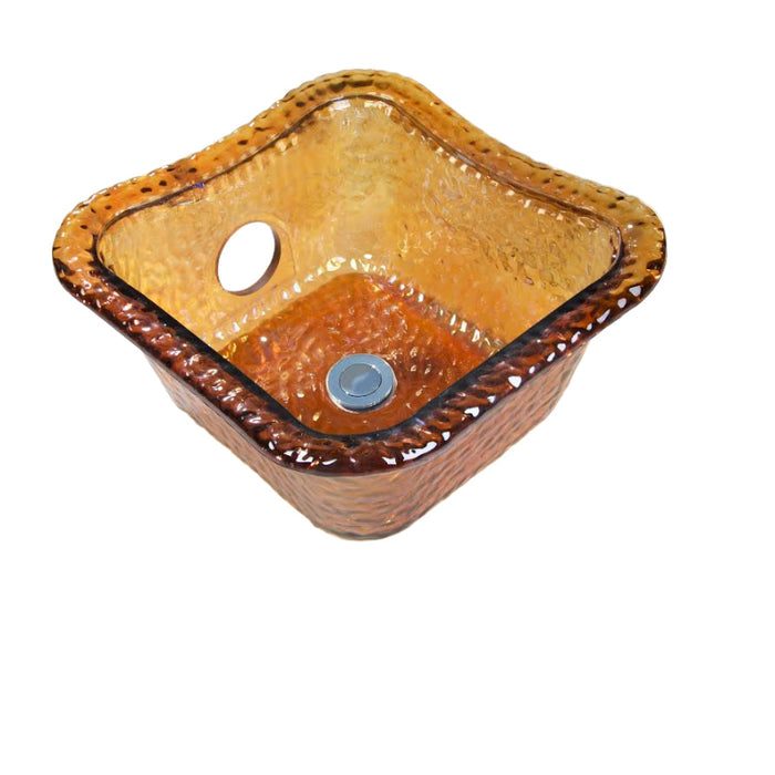 A collection of four square glass bowls in different colors: crystal, nickle, gold, and ruby. Each bowl has a hole for a jet in the center and is textured.