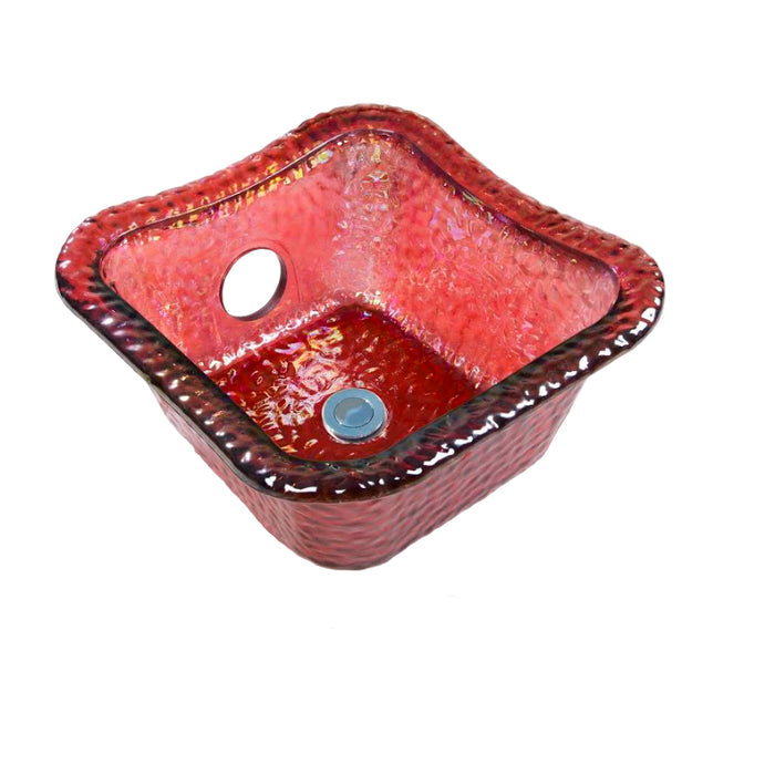A collection of four square glass bowls in different colors: crystal, nickle, gold, and ruby. Each bowl has a hole for a jet in the center and is textured.